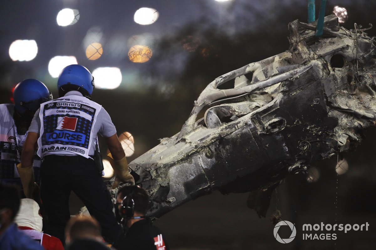 Marshals remove the wreckage after a huge crash for Romain Grosjean, Haas VF-20, on the opening lap